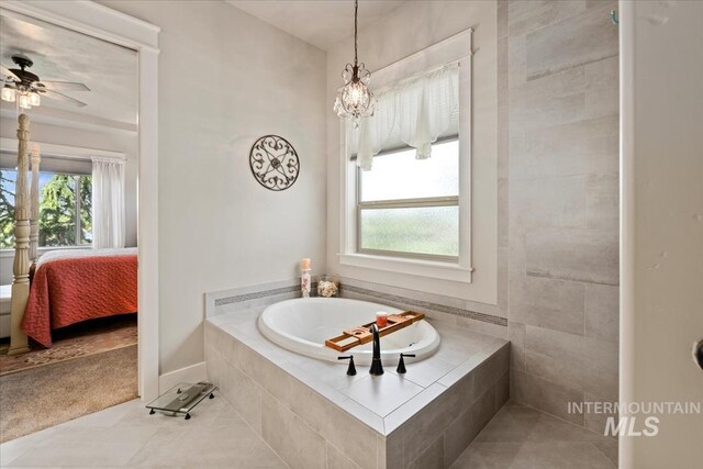 547 S Rivermist Ave, Star, ID 83669 - ensuite bathroom featuring a bath, tile patterned flooring, plenty of natural light, and ceiling fan