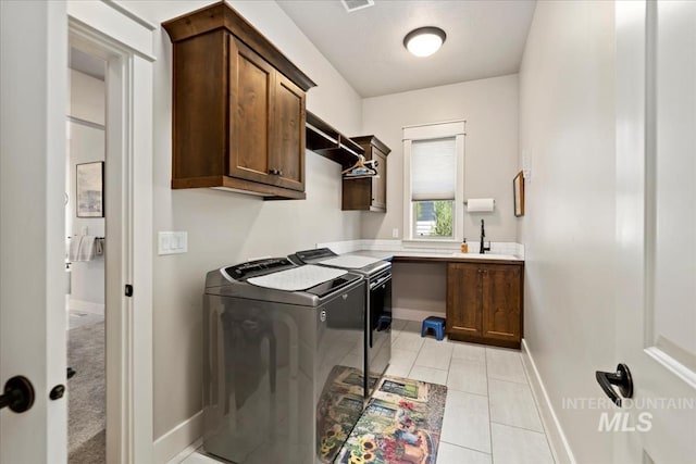547 S Rivermist Ave, Star, ID 83669 - laundry area featuring independent washer and dryer, cabinet space, and light tile patterned flooring