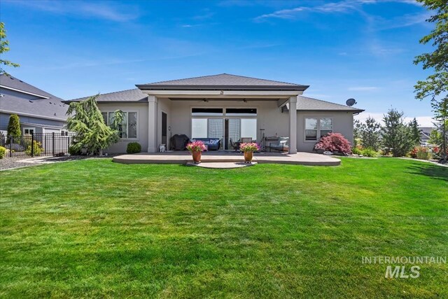 547 S Rivermist Ave, Star, ID 83669 - rear view of house featuring a ceiling fan, stucco siding, and a patio area