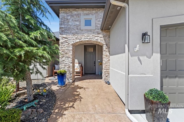 547 S Rivermist Ave, Star, ID 83669 - entrance to property featuring stone siding, stucco siding, and a garage