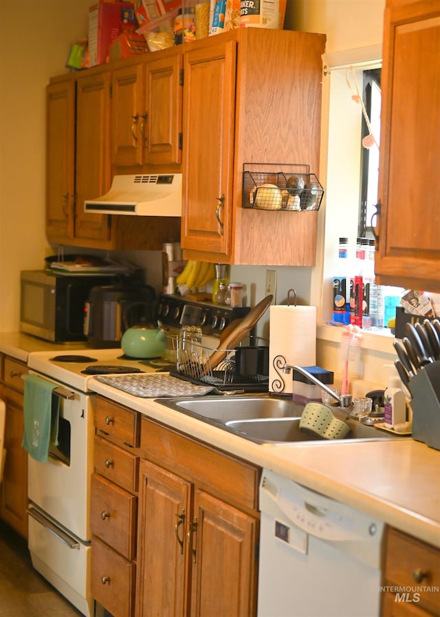 830 Riverside Ave, Orofino, ID 83544 - kitchen featuring range hood, white appliances, light countertops, and brown cabinetry