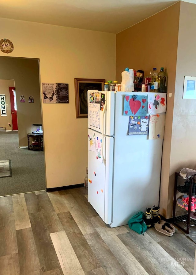 830 Riverside Ave, Orofino, ID 83544 - kitchen featuring freestanding refrigerator, wood finished floors, and a baseboard heating unit