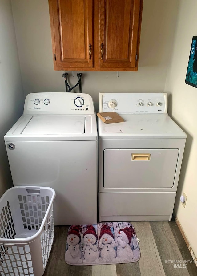 830 Riverside Ave, Orofino, ID 83544 - laundry area featuring wood finished floors, washing machine and clothes dryer, and cabinet space