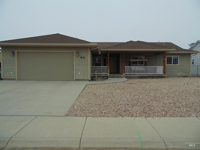 view of front of house featuring a porch and a garage