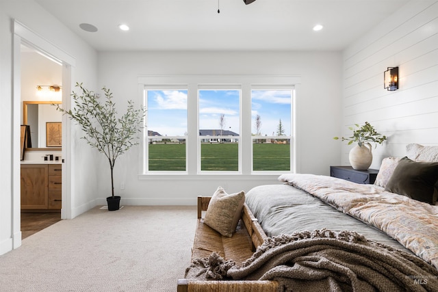 carpeted bedroom featuring baseboards, connected bathroom, and recessed lighting