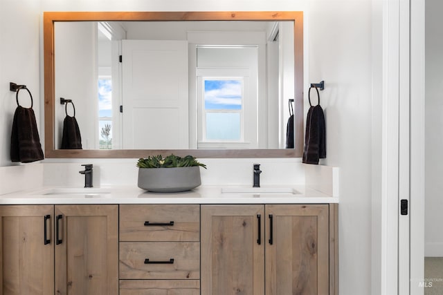 bathroom with a sink and double vanity