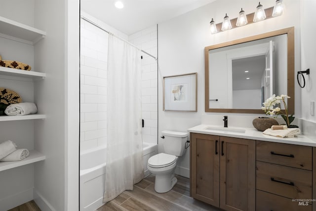 bathroom featuring shower / bath combo, toilet, baseboards, wood finished floors, and vanity
