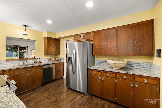 222 Dawn St, Eagle, ID 83616 - kitchen with stainless steel appliances, backsplash, dark wood-style floors, brown cabinets, and recessed lighting