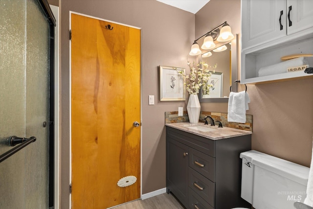 222 Dawn St, Eagle, ID 83616 - bathroom featuring vanity, wood finished floors, and a shower with door