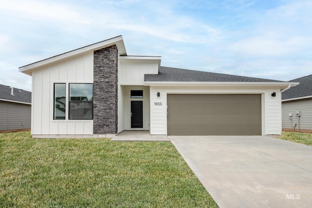 3937 W Tribute St, Meridian, ID 83642 - view of front of house with board and batten siding, a front yard, a garage, concrete driveway, and stone siding