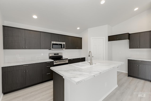 3937 W Tribute St, Meridian, ID 83642 - kitchen with a sink, stainless steel appliances, baseboards, and light wood-style floors