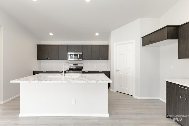 3937 W Tribute St, Meridian, ID 83642 - kitchen with a sink, light stone countertops, baseboards, and appliances with stainless steel finishes
