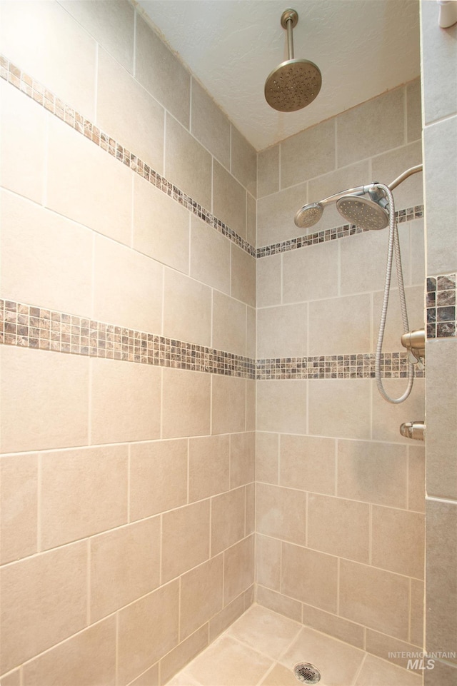 bathroom with a tile shower