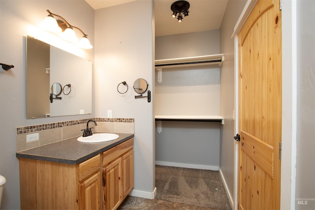 bathroom featuring vanity and decorative backsplash