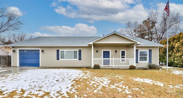 ranch-style home featuring covered porch and a garage