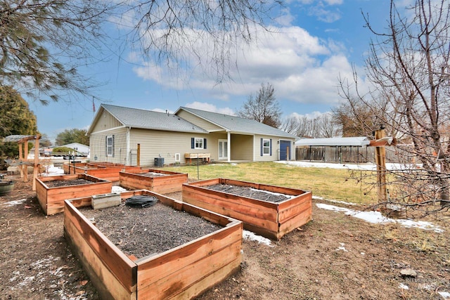 rear view of property with a lawn