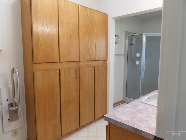 bathroom with vanity, tile patterned floors, and a shower stall