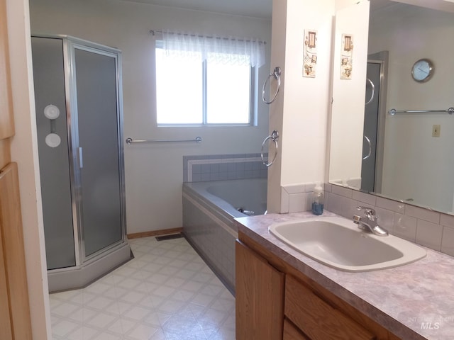 bathroom with a garden tub, tile patterned floors, a stall shower, and vanity