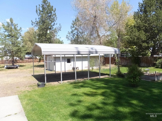 view of outbuilding with fence and a detached carport