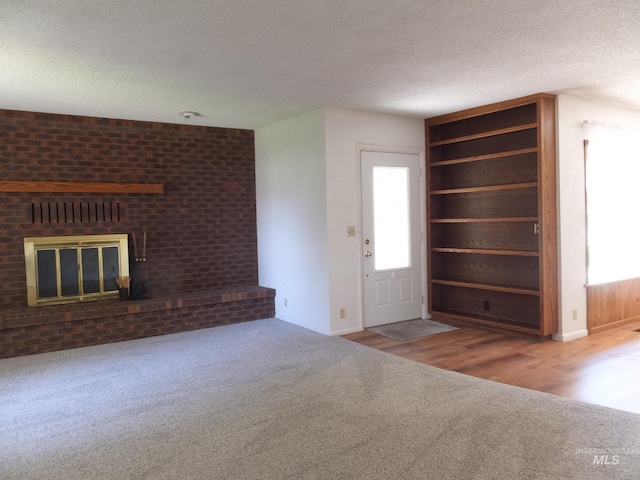 interior space featuring a textured ceiling and a fireplace