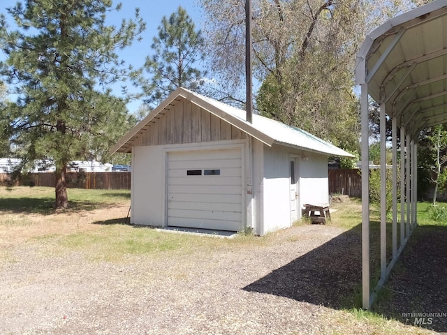 detached garage featuring fence