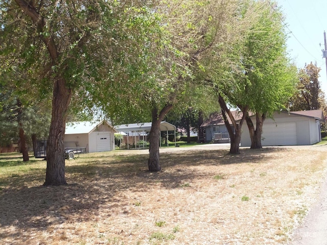 view of front of property featuring a garage and an outbuilding