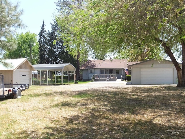 ranch-style home featuring a garage and a detached carport