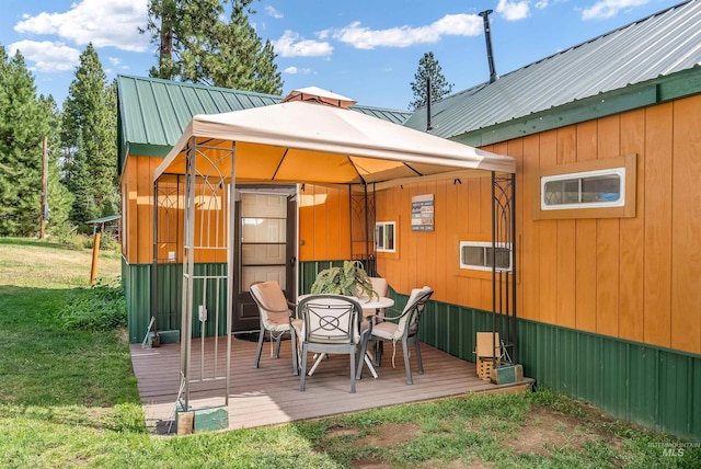 back of property featuring a wooden deck and a yard