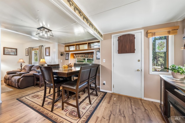 dining area featuring light hardwood / wood-style flooring and plenty of natural light