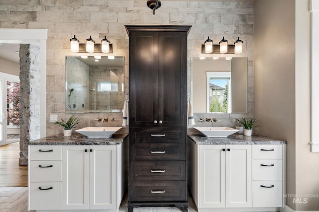 1358 N Morehouse Ave, Eagle, ID 83616 - bathroom with a shower stall, wood finished floors, two vanities, and backsplash