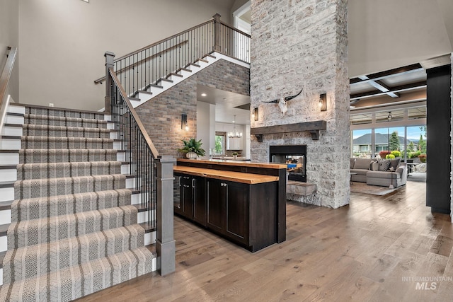 1358 N Morehouse Ave, Eagle, ID 83616 - stairs featuring a high ceiling, a fireplace, wood finished floors, and beam ceiling