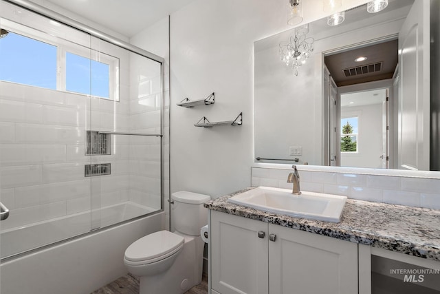 1358 N Morehouse Ave, Eagle, ID 83616 - bathroom with toilet, vanity, shower / bath combination with glass door, and tasteful backsplash