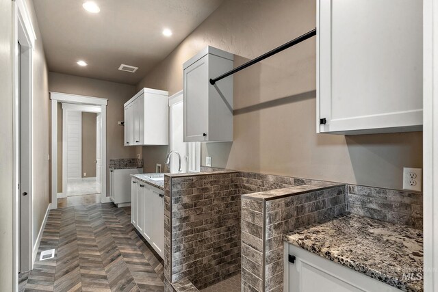 1358 N Morehouse Ave, Eagle, ID 83616 - kitchen with a sink, white cabinets, recessed lighting, light stone countertops, and baseboards