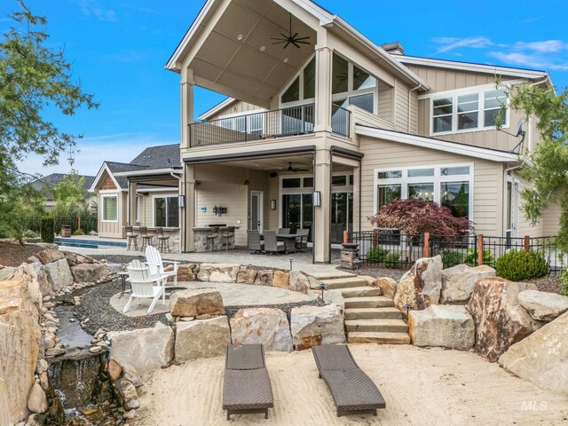 1358 N Morehouse Ave, Eagle, ID 83616 - rear view of property featuring a balcony, a ceiling fan, a patio, fence, and board and batten siding