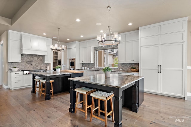 1358 N Morehouse Ave, Eagle, ID 83616 - kitchen featuring a chandelier, a kitchen island, appliances with stainless steel finishes, recessed lighting, and tasteful backsplash