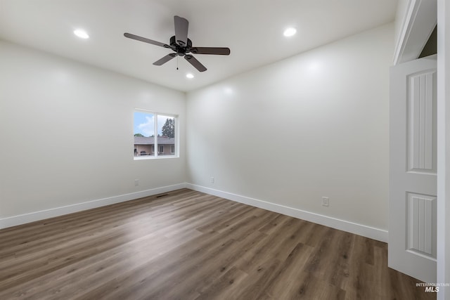 spare room featuring ceiling fan, recessed lighting, wood finished floors, visible vents, and baseboards