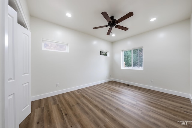 empty room featuring ceiling fan, recessed lighting, wood finished floors, and baseboards