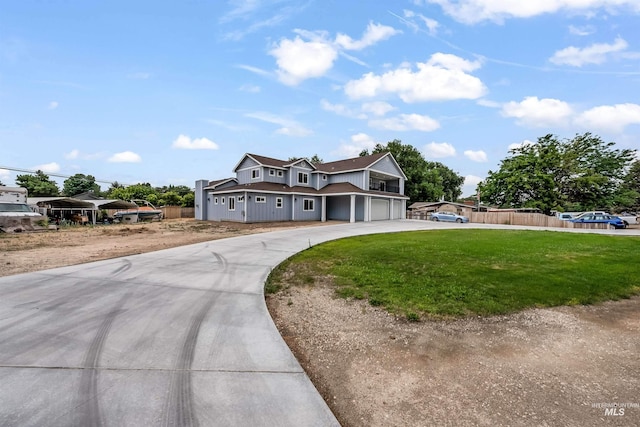 view of front of property featuring a garage, concrete driveway, fence, and a front lawn