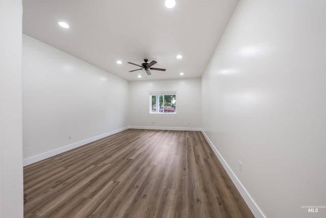 empty room with ceiling fan, baseboards, wood finished floors, and recessed lighting