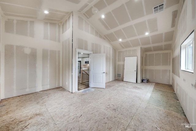 bonus room featuring high vaulted ceiling and visible vents