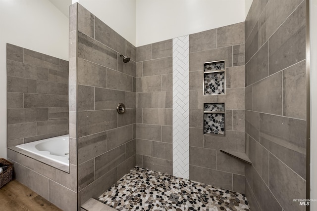 full bath with tiled shower, a garden tub, and wood finished floors