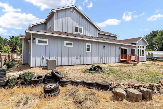 back of property featuring central air condition unit, a shingled roof, and board and batten siding