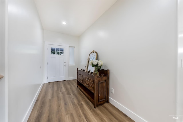 entryway with wood finished floors and baseboards