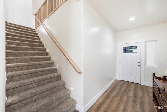 foyer with stairs, recessed lighting, baseboards, and wood finished floors