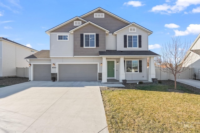 view of front of home featuring a garage, covered porch, and a front lawn