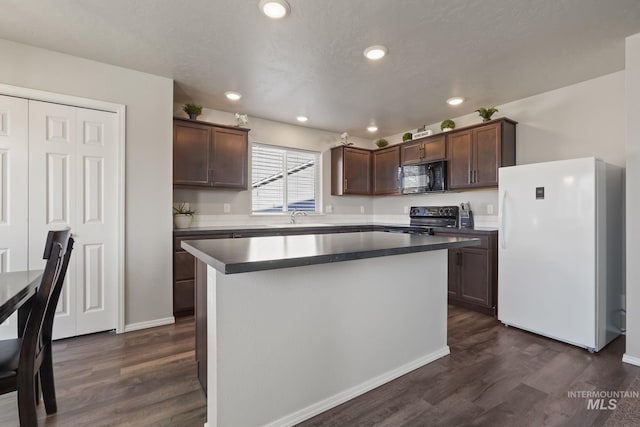 kitchen featuring dark hardwood / wood-style flooring, sink, black appliances, and a center island