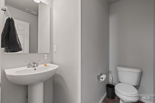 bathroom with sink, wood-type flooring, and toilet