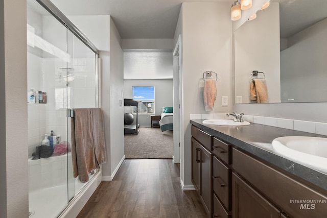 bathroom featuring vanity, a shower with door, and hardwood / wood-style floors