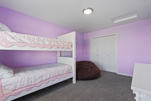 bedroom featuring dark carpet and a closet