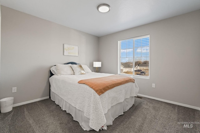 bedroom featuring dark carpet